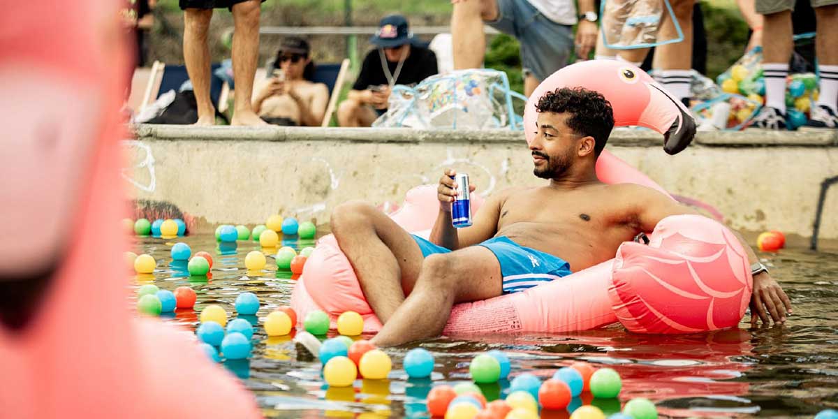 Red Bull MaxPool Party guy in big pink floatable flamengo.