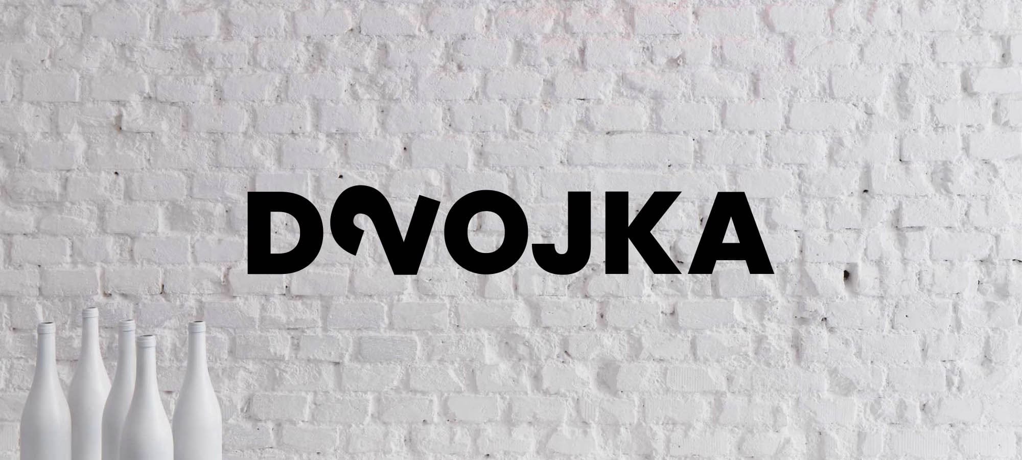 Logo of winebar Dvojka on the wall.